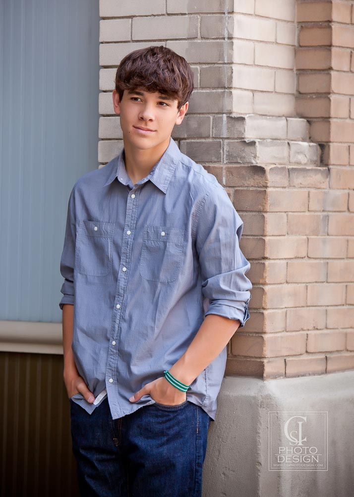 Senior boy in a blue shirt and brick corner