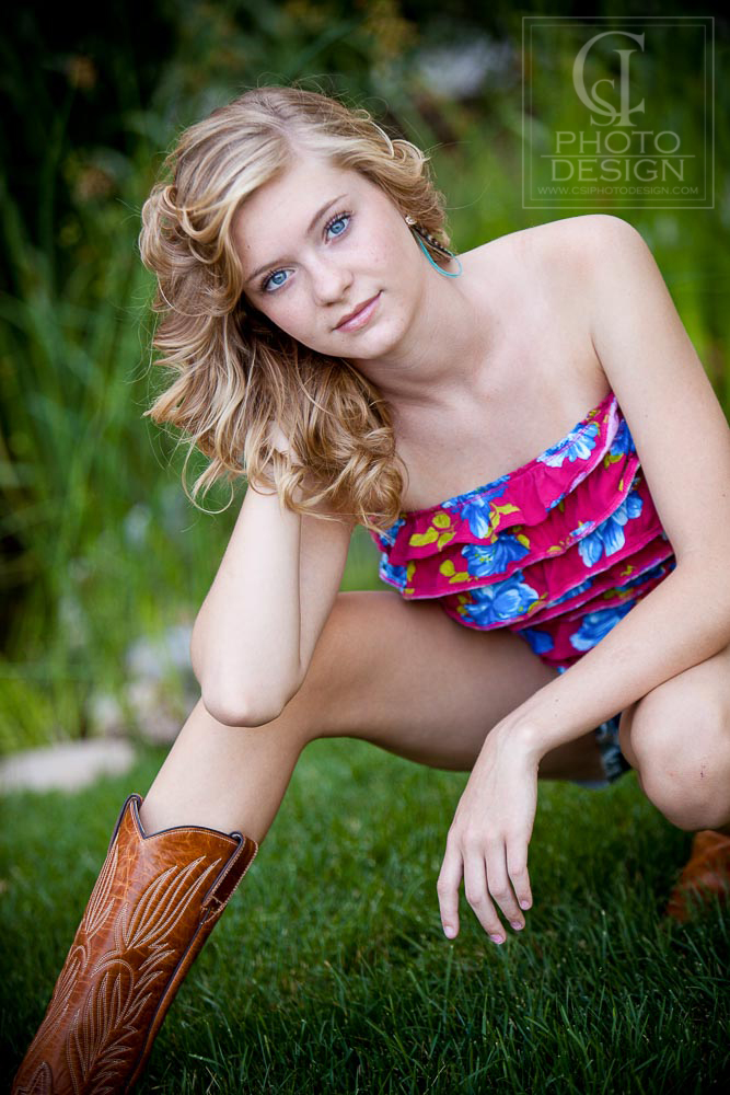 Senior girl in pink floral top and cowboy boots